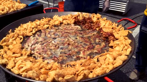 Pork-rinds-being-fried-in-a-giant-skillett