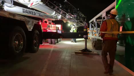 Construction-workers-setting-up-a-crane-before-hanging-a-structure