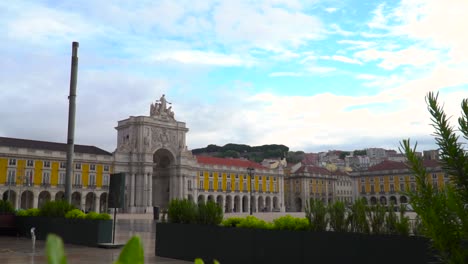 Reveal-of-Praca-de-Comercio-square-through-of-green-plants