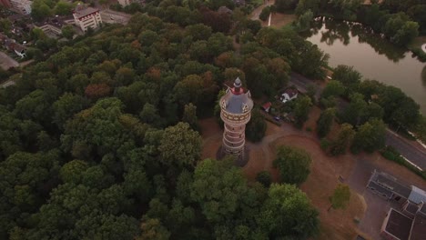 A-slow-and-steady-reveal-of-a-water-tower-surrounded-by-suburban-area