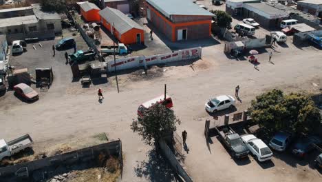 A-Rising-Drone-shot-of-an-Industrial-Ware-house-Complex-on-a-Sunny-Day