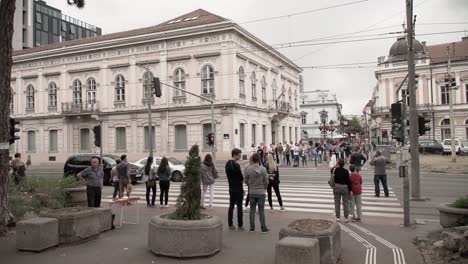 Pedestrians-crossing-a-cross-walk-in-Belgrade,-Serbia