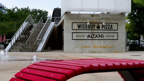 Bright-red-modern-seating-near-fountains-in-a-plaza-outside-of-restaurants-in-the-Navy-Yard-area-of-Washington,-DC