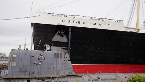 Panning-shot-revealing-a-soviet-antique-submarine-and-a-large-cruise-ship-in-profile