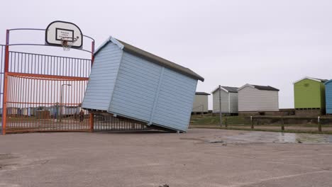 Pan-to-reveal-beach-hut-leaning-against-basketball-hoop