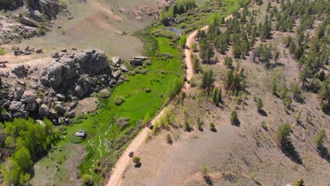 Aerial-view-tracks-3-UTVS-and-pans-up