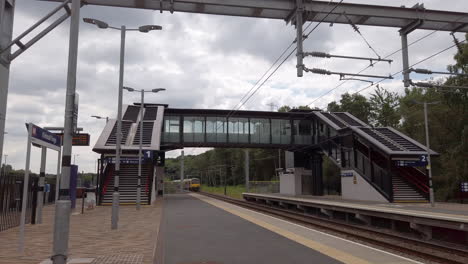 Northern-Train-Passing-Through-an-Empty-Commuter-Station-at-the-Weekend-Travelling-Towards-Camera-in-Slow-Motion