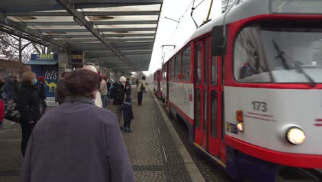 People-waiting-for-public-transportation-wearing-facemask-during-covid-19-coronavirus-pandemic-in-Olomouc,-Czech-Republic