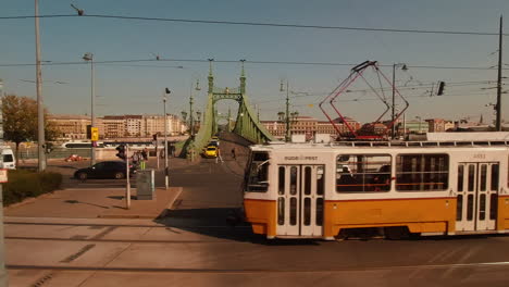 Pass-by-green-metal-bridge-over-river-Danube-in-city-of-Budapest-Hungary