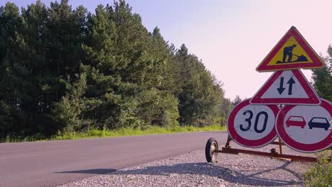 Traffic-Signs-And-Symbols-On-The-Roadside-In-Omurtag,-Bulgaria---close-up,-low-level-shot