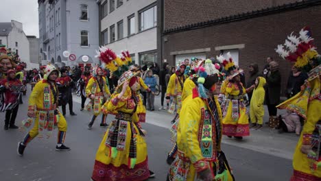 Aalst-carnival-parade-participants-dancing-in-yellow-and-red-costumes