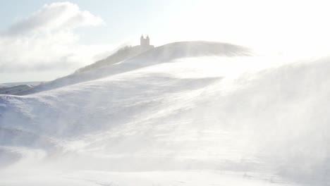 High-speed-winds-are-drifting-snow-in-hilly-mountain-area