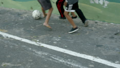 Hand-held-shot-of-boys-South-African-playing-with-plastic-bottles-on-a-rope-in-a-township-playground-Salamander-Park-in-Hangberg-residential-area