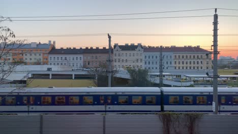 Various-scenes-of-commuter-trains-passing-in-front-of-buildings-in-the-city-of-Vienna,-Austria