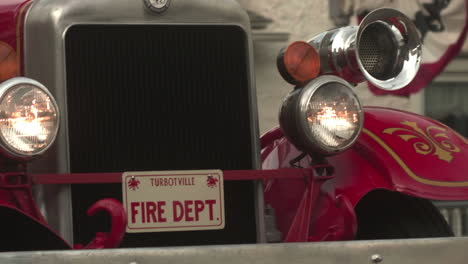 Antique-fire-truck-in-parade-in-Turbotville,-Pennsylvania,-Close,-Slow-Motion