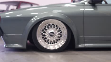 BBS-Shiny-Silver-Allow-Wheel-Rim-and-Tire-on-Vintage-Old-Car-Dolly-Close-Up-Shot