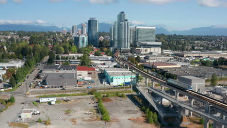 Vancouver-Cityscape-With-SkyTrain-Approaching-Marine-Drive-Station-In-British-Columbia,-Canada-At-Daytime