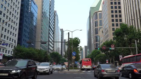 Gangnam-District-with-busy-traffic-looking-up-at-high-rise-buildings,-South-Korea