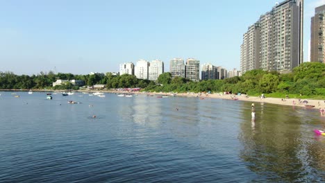 Hong-Kong-Wu-Kai-Sha-beach-and-coastline-with-residential-skyscrapers-in-the-background,-Aerial-view