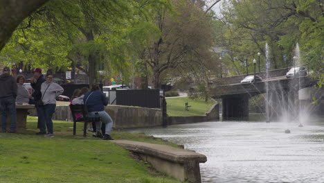 A-group-of-people-resting-next-to-Sager-Creek-in-Siloam-Springs,-Arkansas