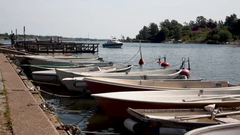 Boats-docked-at-port-of-Helsinki-on-calm-sunny-day,-long-shot