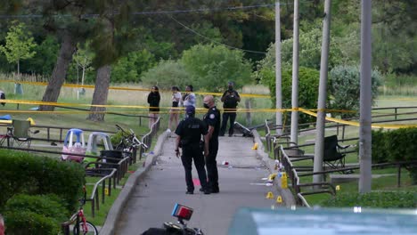 Police-Personnel-At-The-Cordoned-Area-Of-A-Shooting-Incident-In-Toronto,-Canada-At-Daytime