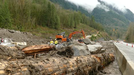 A-large-bulldozer-clears-the-forest-road-at-the-construction-site-near-the-mountain-road