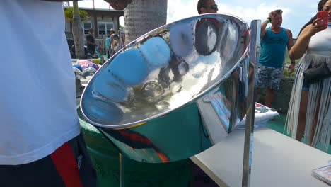 Slow-motion-shot-of-an-audience-and-a-man-playing-on-a-steelpan-drum