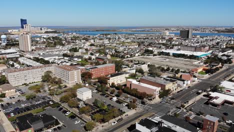 A-slowly-forward-moving-wide-aerial-view-of-downtown-tourist-district-of-Atlantic-City,-New-Jersey