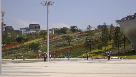 Cleaning-and-garden-workers-are-washing-the-floor-in-the-Friendship-park-while-visitor-are-walking-around-the-park