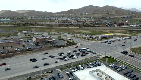 A-busy-intersection-near-Traverse-Mountain-and-Silicon-Slopes-in-Lehi,-Utah-with-housing-in-the-foothills