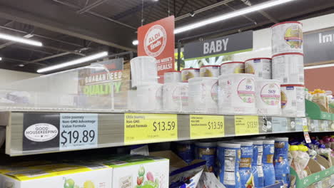 Handheld-shot-of-bare-shelves-of-baby-formula-in-n-Aldi-grocery-store