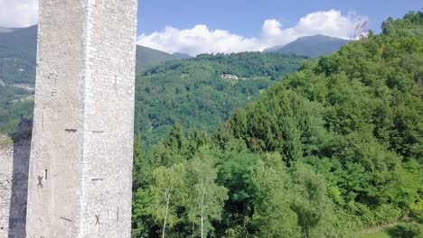 Aerial-view-of-the-Tower-of-Castel-Telvana-in-Borgo-Valsugana,-Trentino,-Italy-with-drone-flying-forward-on-a-very-clear-day