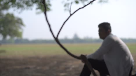 Silhouette-sad-and-depressed-young-male-sitting-in-playground-near-trees