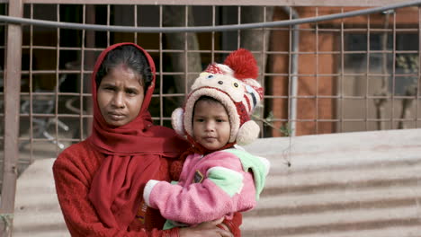 Portrait-of-young-woman-holding-child