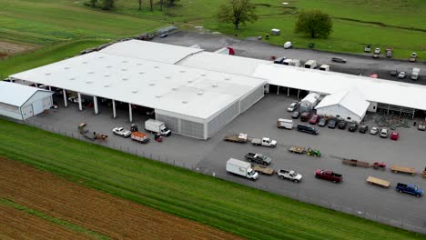 Aerial-drone-shot-of-staplers-unloading-produce-from-wagons-and-trailers