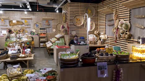 Panning-walk-through-shot-of-souvenir-shoppers-browsing-products-in-luxury-shopping-mall,-Icon-Siam,-Bangkok,-Thailand