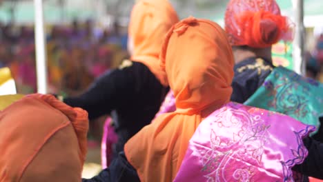 Zeitlupe,-Nahaufnahme-Von-Hinten:-Philippinische-Muslimische-Frauen-In-Farbenfroher-Kleidung,-Die-Während-Einer-Veranstaltung-Zur-Feier-Des-Nationalen-Frauenmonats-In-Mindanao-Mit-Fans-Einen-Tanz-Aufführen