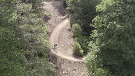 Aerial-View-of-mountain-biker-riding-downhill-on-a-bike-trail-in-the-vosges-mountains,-France