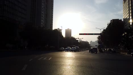 Xian,-China---July-2019-:-Morning-view-of-the-bus-driving-through-and-cars-waiting-on-a-busy-crossoroad-in-the-city-of-Xian-in-summer,-Shaanxi-Province