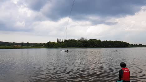 A-slow-motion-shot-of-a-man-cable-skiing-on-a-lake