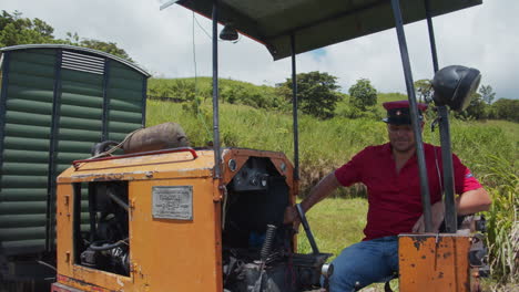 Shot-of-Swiss-train-captain-driving-small-old-fashioned-train-in-Arenal-national-park-in-Costa-Rica