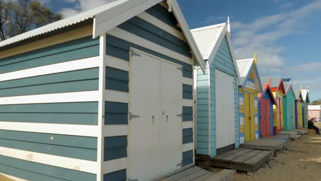 Tourists-walking-and-taking-photo-at-Brighton-Bathing-Boxes,-Melbourne,-Australia