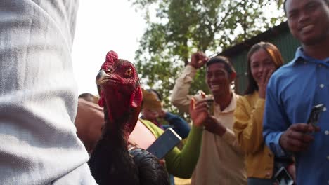 Locals-of-Siem-Reap,-Cambodia,-happy-to-learn-agricultural-techniques-and-chicken-insemination-and-vaccination---low-angle-shot