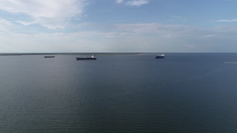 This-is-an-aerial-video-over-cargo-ships-entering-a-port-in-Galveston,-Texas