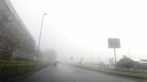 POV-dashboard-driving-in-British-fog-weather-urban-road-traffic