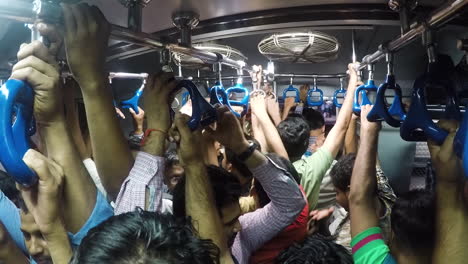 High-viewpoint-of-crowded-train-and-people-holding-on