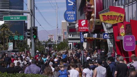 A-crowd-of-tourists-crossing-a-street-on-the-strip-in-Las-Vegas,-Nevada