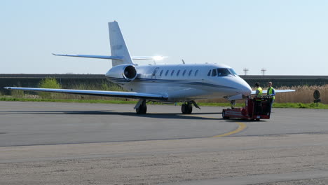 Private-jet-being-towed-by-ground-crew