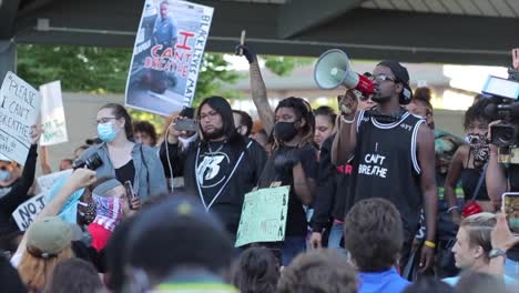 Speaker-at-BLM-demonstration-steps-forward-to-talk-through-megaphone